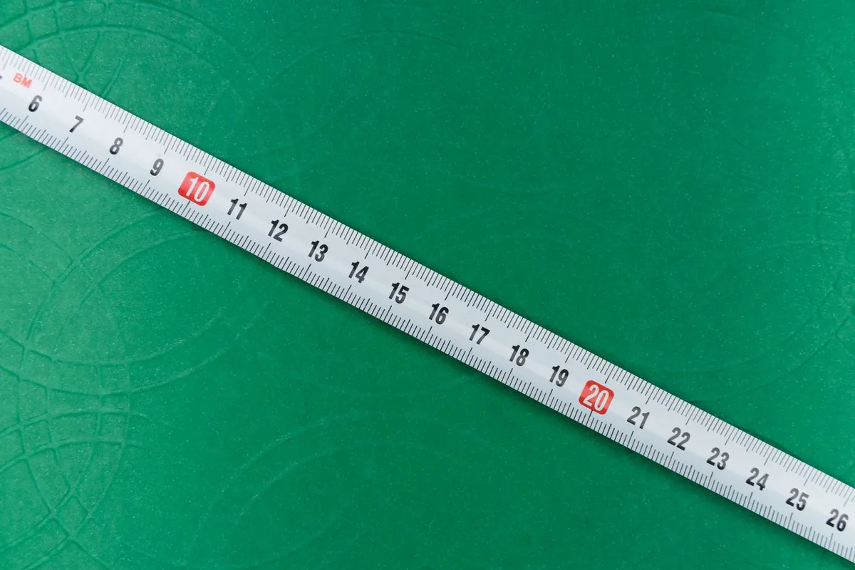 Tape measure on a green surface
