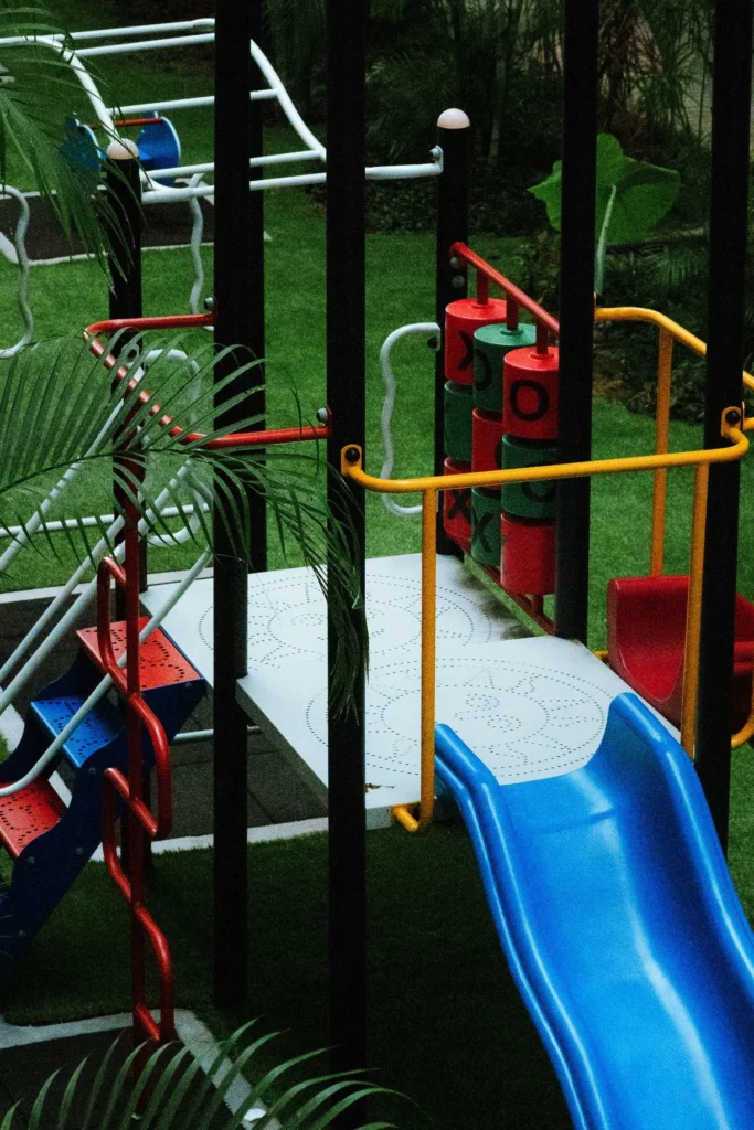 Colorful childrens playground on a green turf play surface